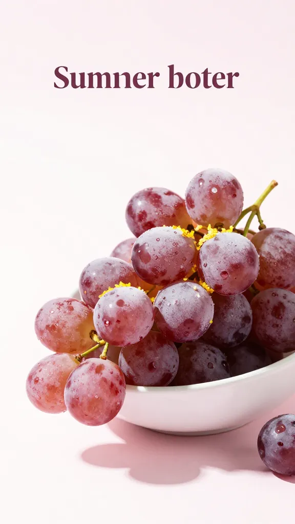 Studio shot of clear glass bowl of frozen grapes, lemon zest garnish